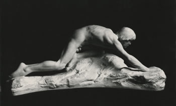 stone sculpture of crawling figure