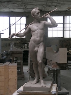 stone sculpture of standing man back